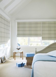 Hunter Douglas Design Studio Roman Shades in a blue bedroom