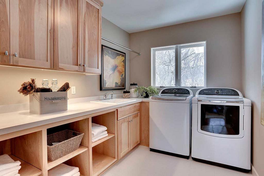 laundry room with cabinets, storage